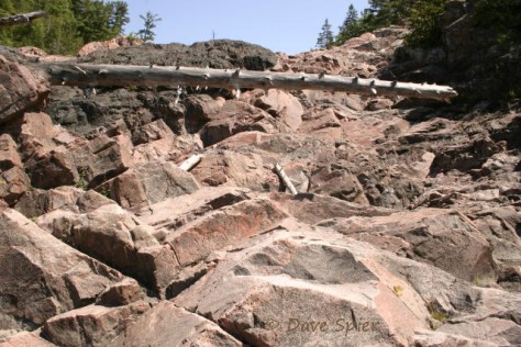 A small remnant of the gray Keweenawan basalt covers the pink granite as we climb toward the lower Chippewa Falls.