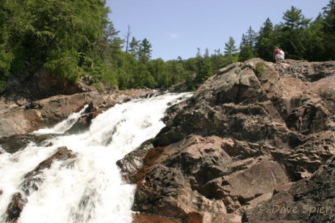 several visitors provide scale next to the crest of the lower Chippewa Falls
